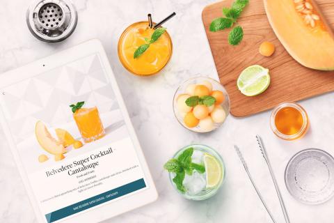 recipe on tablet with cocktail ingredients