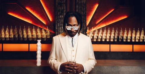 Global music icon Future holding a glass of Belvedere 10 in front of the Belvedere Bar.