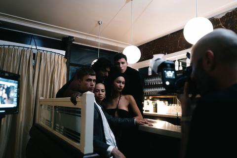 LP-Dirty-Brew-people posing for a photo in front of a bar with a Dirty Brew Bottle